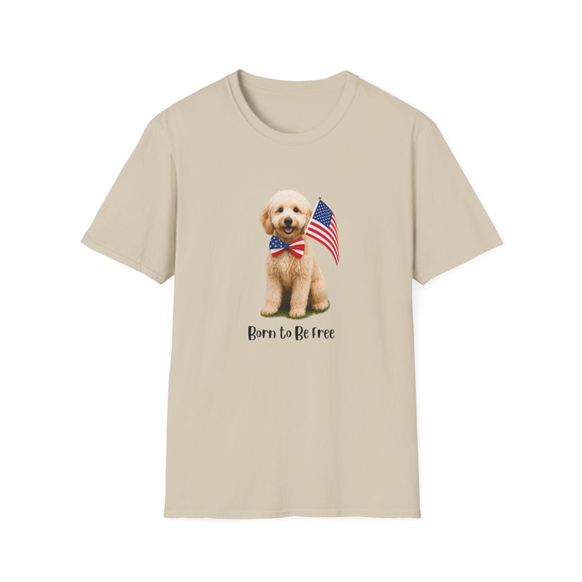 T-shirt featuring a cute golden doodle puppy wearing an American flag bow tie and holding a small U.S. flag, with the phrase 'Born to Be Free' printed below the image.