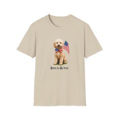 T-shirt featuring a cute golden doodle puppy wearing an American flag bow tie and holding a small U.S. flag, with the phrase 'Born to Be Free' printed below the image.