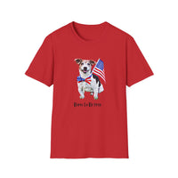 T-shirt featuring a cute  puppy wearing an American flag bow tie and holding a small U.S. flag, with the phrase 'Born to Be Free' printed below the image.