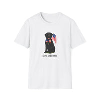 White t-shirt featuring a patriotic Black Lab wearing an American flag bowtie and holding U.S. flags, with the Black Labphrase "Born to Be Free" printed below — perfect for dog lovers and patriotic Americans.