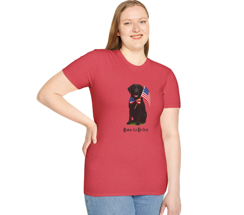 Heather Red  t-shirt featuring a patriotic Black Lab wearing an American flag bowtie and holding U.S. flags, with the Black Lab phrase "Born to Be Free" printed below — perfect for dog lovers and patriotic Americans.