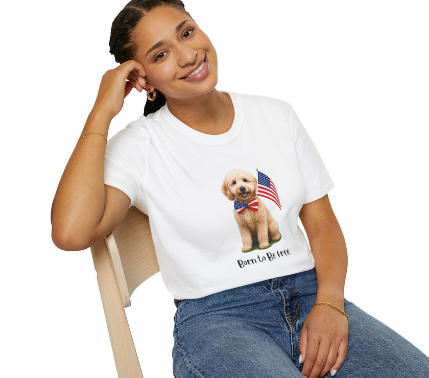 Female wearing T-shirt featuring a cute golden doodle puppy wearing an American flag bow tie and holding a small U.S. flag, with the phrase 'Born to Be Free' printed below the image.