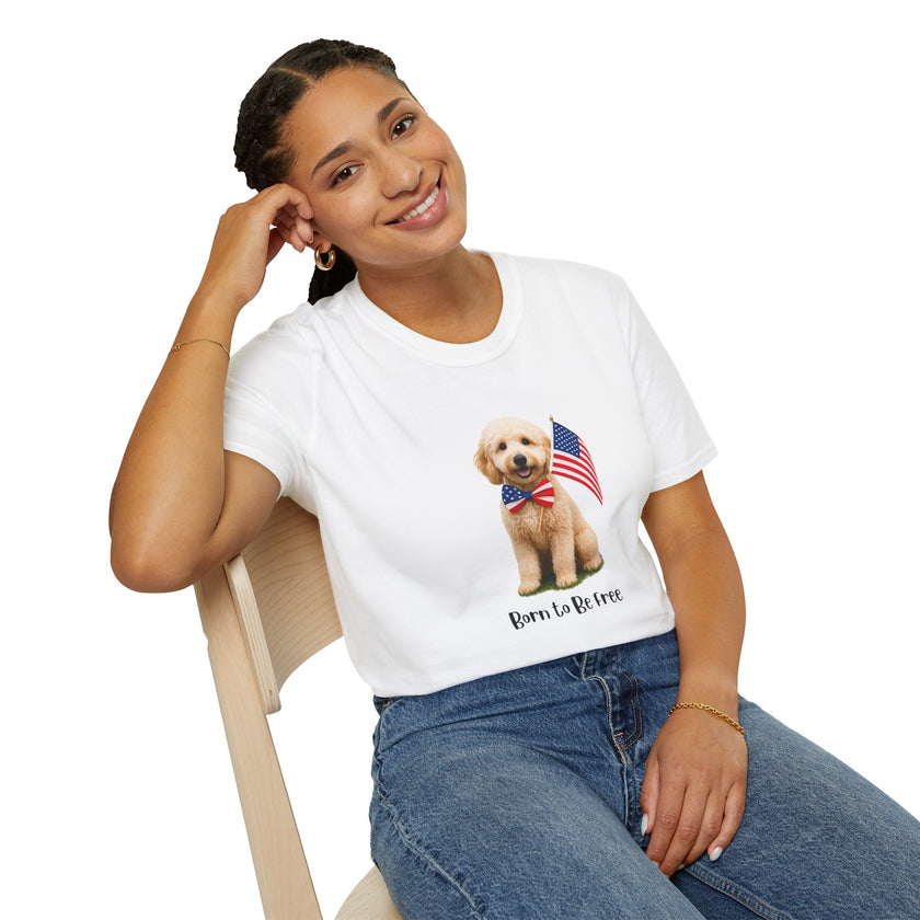 Female wearing T-shirt featuring a cute golden doodle puppy wearing an American flag bow tie and holding a small U.S. flag, with the phrase 'Born to Be Free' printed below the image.