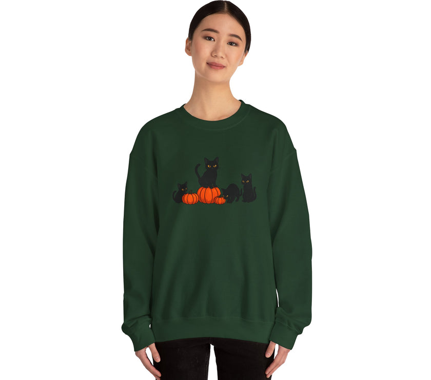 Person wearing a green sweatshirt with black cats and pumpkins design on a white background