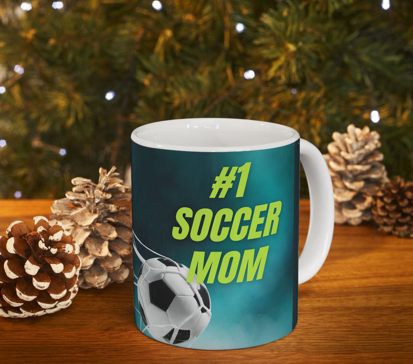 Mug with '#1 Soccer Mom' text and soccer ball design on a teal background