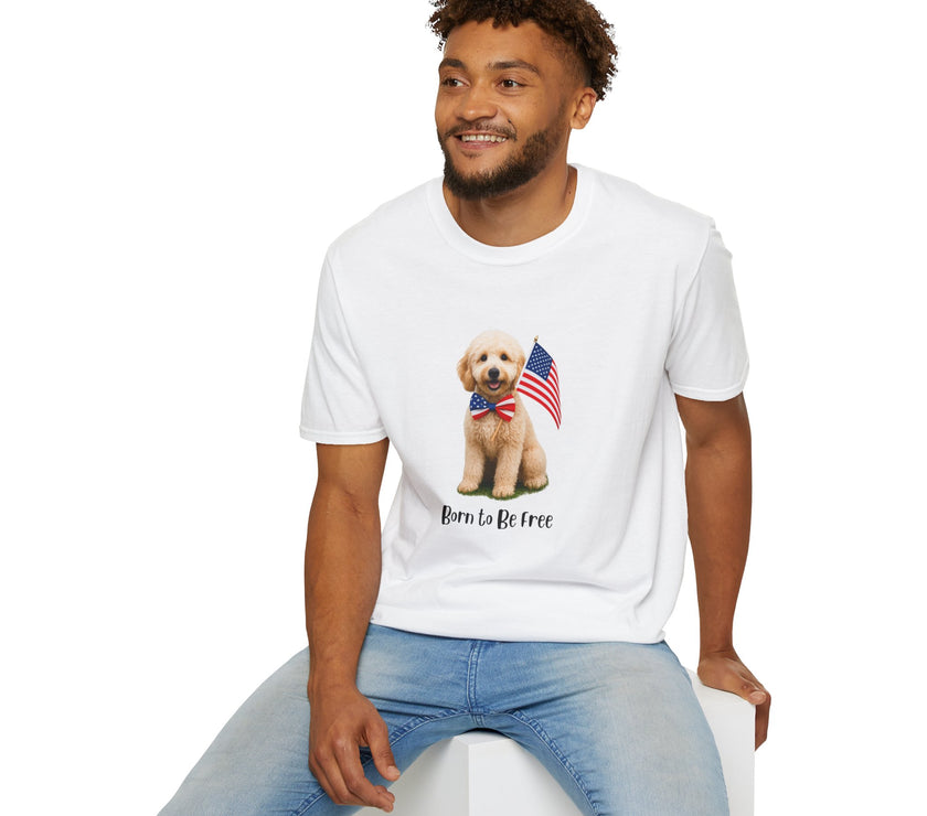 Male wearing T-shirt featuring a cute golden doodle puppy wearing an American flag bow tie and holding a small U.S. flag, with the phrase 'Born to Be Free' printed below the image.