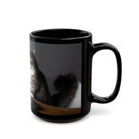Black ceramic mug featuring a cartoon-style image of a cat sitting at a computer with the funny quote “I work hard so my cat can have a better life.”