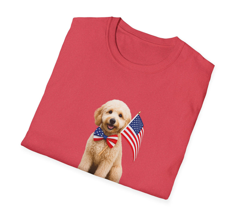 FoldedT-shirt featuring a cute golden doodle puppy wearing an American flag bow tie and holding a small U.S. flag, with the phrase 'Born to Be Free' printed below the image.
