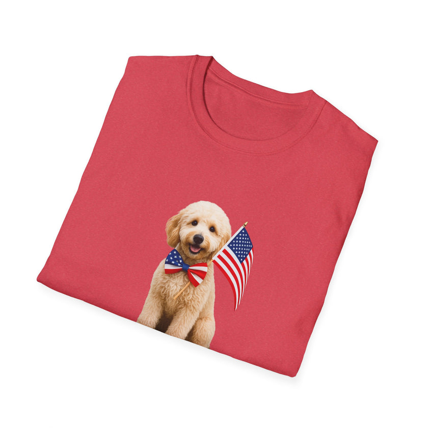 FoldedT-shirt featuring a cute golden doodle puppy wearing an American flag bow tie and holding a small U.S. flag, with the phrase 'Born to Be Free' printed below the image.
