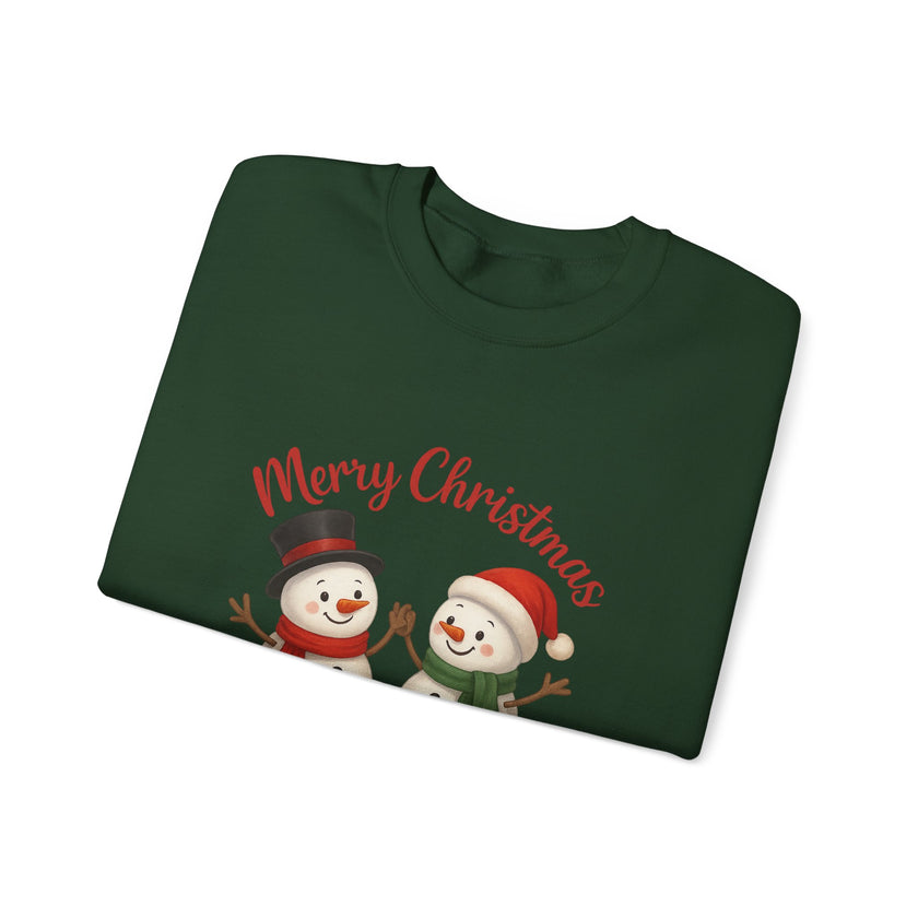Folded green Christmas sweater with snowmen and 'Merry Christmas' text on a white background