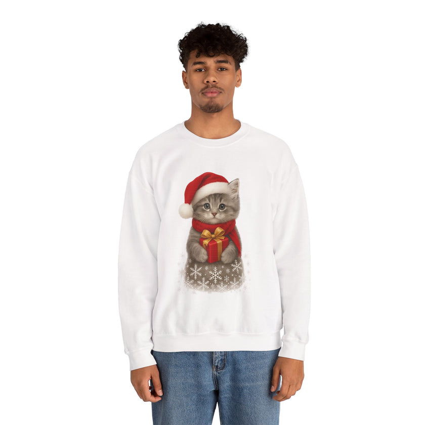 White sweatshirt featuring a gray kitten wearing a Santa hat and red scarf, holding a small red gift box with a gold bow, surrounded by snowflake designs.