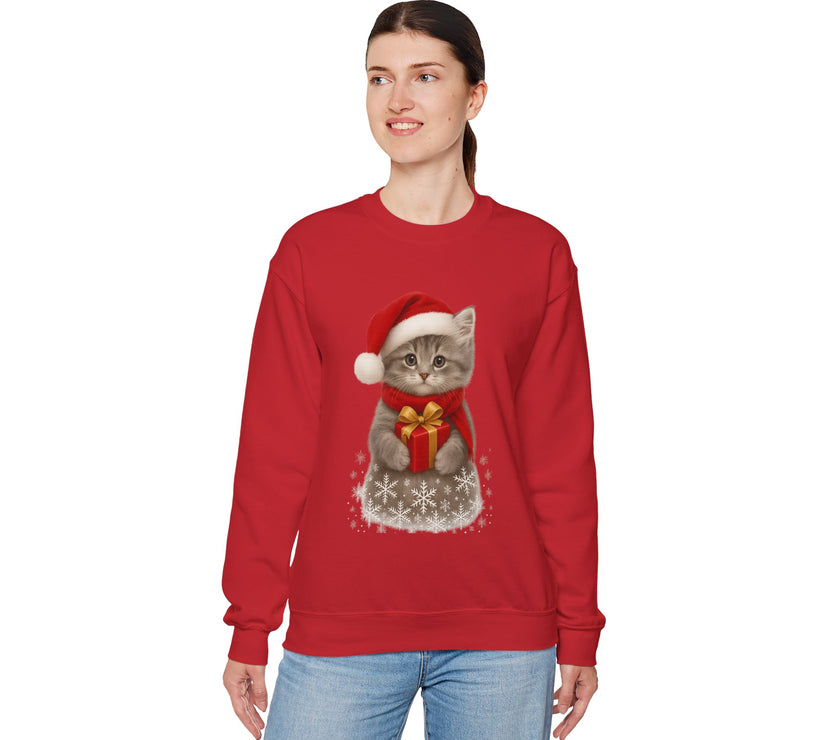 Red sweatshirt featuring a gray kitten wearing a Santa hat and red scarf, holding a small red gift box with a gold bow, surrounded by snowflake designs.
