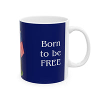 A ceramic mug featuring a Rottweiler sitting on grass, wearing a red, white, and blue bow tie, and holding an American flag against a dark blue background. with the message "Born to be Free"