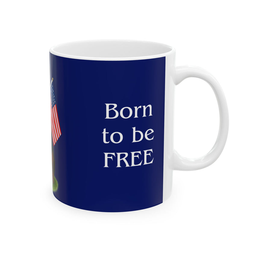 A ceramic mug featuring a Rottweiler sitting on grass, wearing a red, white, and blue bow tie, and holding an American flag against a dark blue background. with the message "Born to be Free"