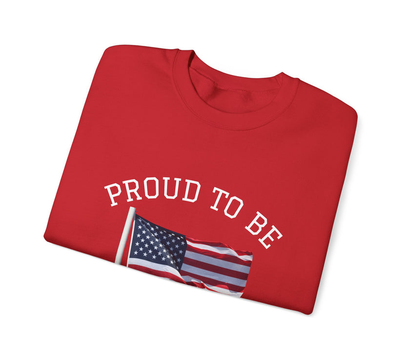Folded red shirt with 'PROUD TO BE' text and American flag on a white background