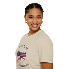 Smiling woman  wearing a white t-shirt with an American flag graphic and the words 'Proud to Be an American' printed around the flag