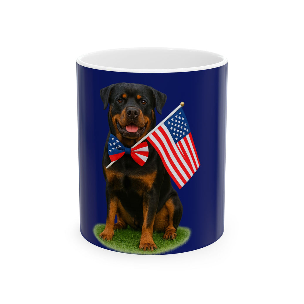 A ceramic mug featuring a Rottweiler sitting on grass, wearing a red, white, and blue bow tie, and holding an American flag against a dark blue background. with the message "Born to be Free"