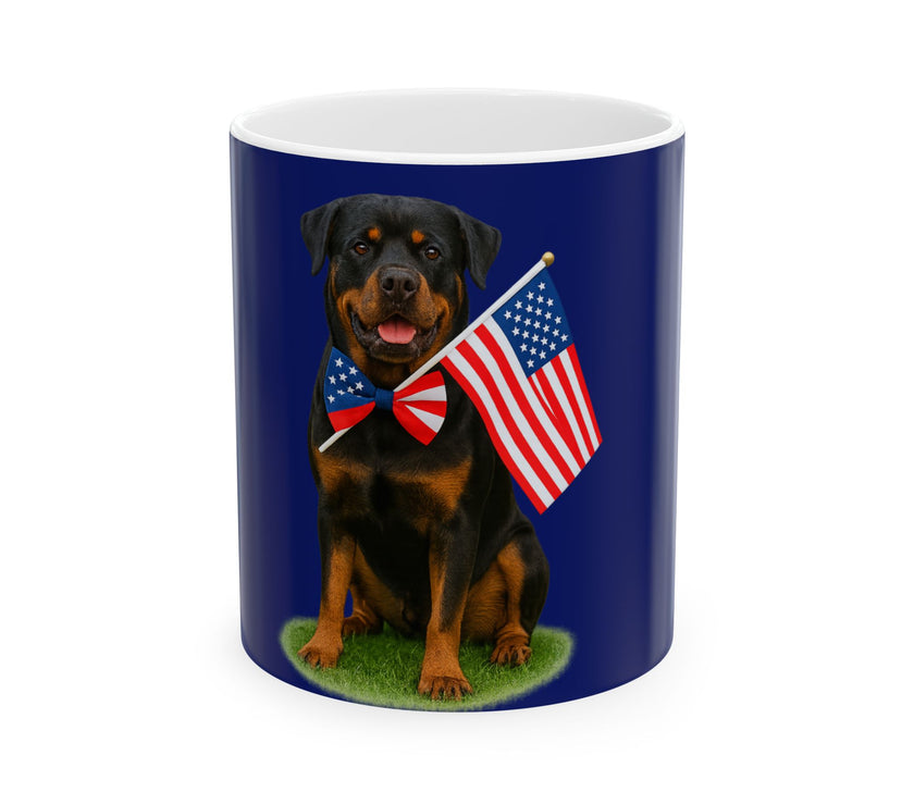A ceramic mug featuring a Rottweiler sitting on grass, wearing a red, white, and blue bow tie, and holding an American flag against a dark blue background. with the message "Born to be Free"