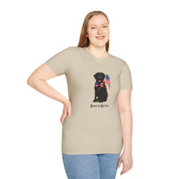Sand t-shirt featuring a patriotic Black Lab wearing an American flag bowtie and holding U.S. flags, with the Black Labphrase "Born to Be Free" printed below — perfect for dog lovers and patriotic Americans.