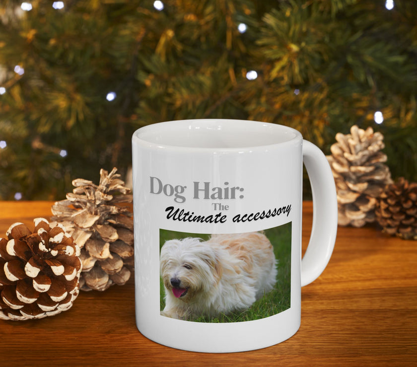 White ceramic mug featuring a photo of dogs lying on grass, with the humorous quote "Dog Hair: The Ultimate Accessory" printed below the image.