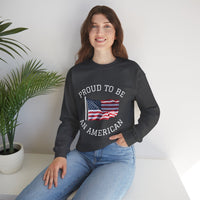 Person wearing a black sweatshirt with 'Proud to be an American' text and flag design, sitting indoors.