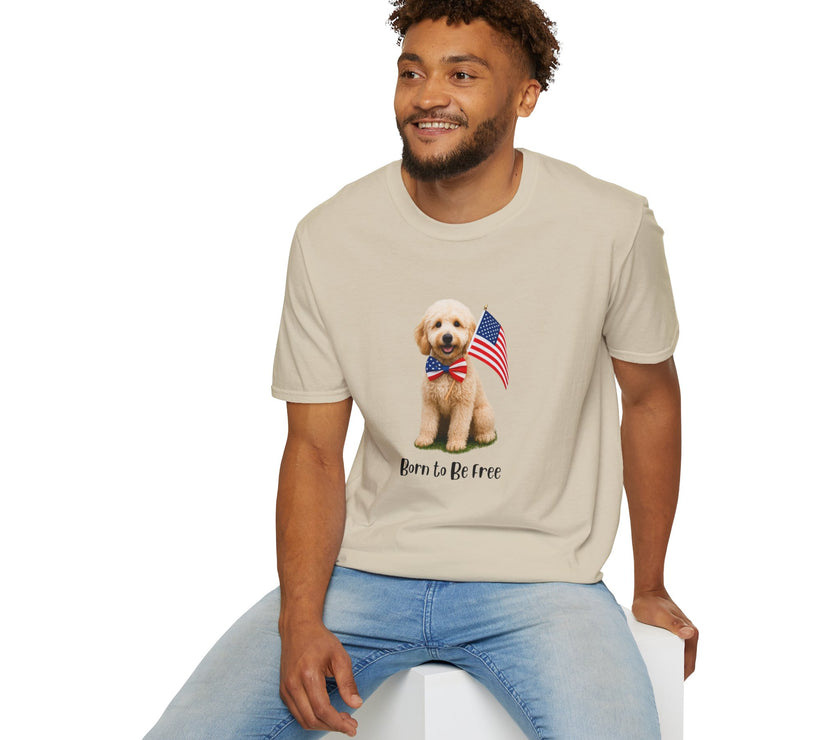 Male wearing T-shirt featuring a cute golden doodle puppy wearing an American flag bow tie and holding a small U.S. flag, with the phrase 'Born to Be Free' printed below the image.