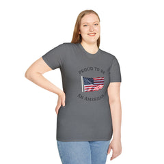 Smiling woman  wearing a white t-shirt with an American flag graphic and the words 'Proud to Be an American' printed around the flag