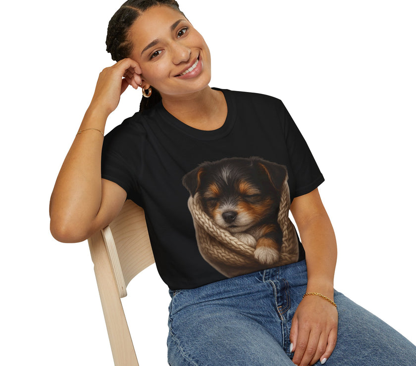 Person wearing a black t-shirt with a dog graphic, sitting on a chair against a white background