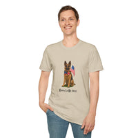 Beige t-shirt featuring a patriotic German Shepherd wearing an American flag bowtie and holding U.S. flags, with the phrase "Born to Be Free" printed below — perfect for dog lovers and patriotic Americans.