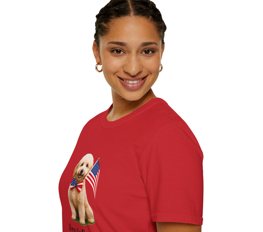 Female wearing T-shirt featuring a cute golden doodle puppy wearing an American flag bow tie and holding a small U.S. flag, with the phrase 'Born to Be Free' printed below the image.