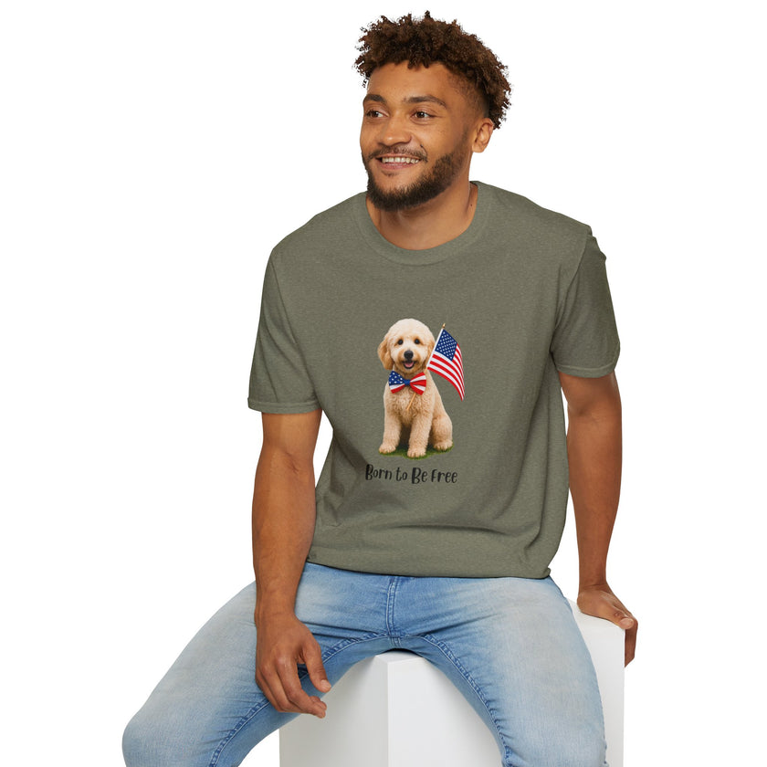 Male wearing T-shirt featuring a cute golden doodle puppy wearing an American flag bow tie and holding a small U.S. flag, with the phrase 'Born to Be Free' printed below the image.