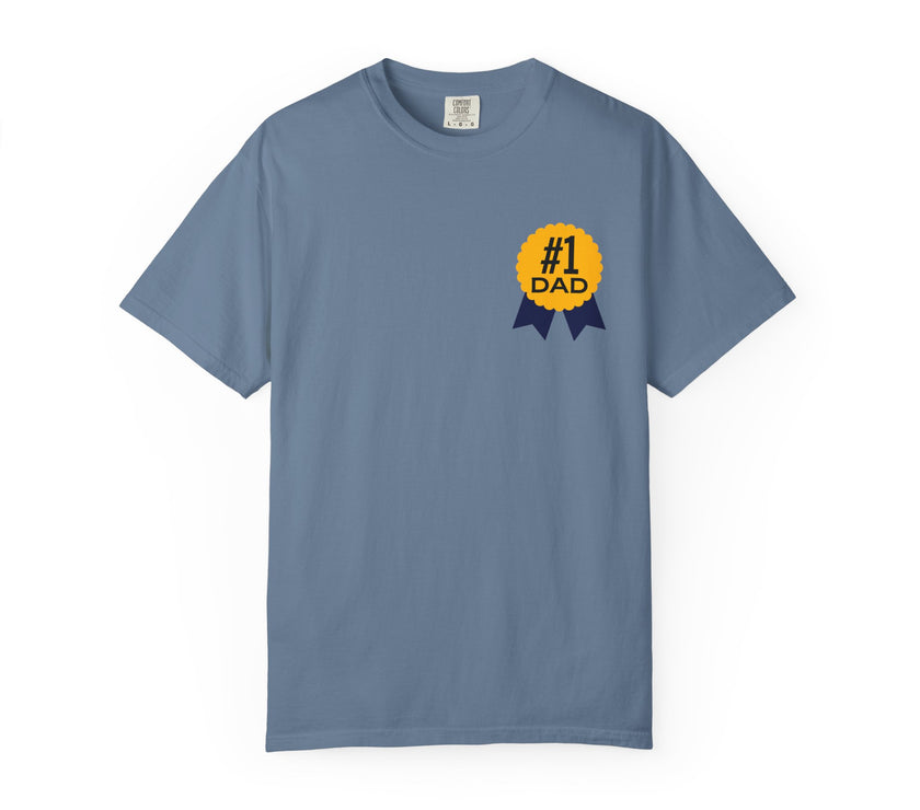 Jean color t-shirt featuring a yellow and navy blue award ribbon graphic on the chest with the text "#1 Dad," designed as a fun and heartfelt Father's Day gift.