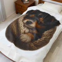 Blanket with Puppy wrapped in a knitted blanket on a white 