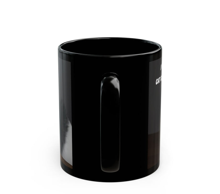 Black ceramic mug featuring a cartoon-style image of a cat sitting at a computer with the funny quote “I work hard so my cat can have a better life.”