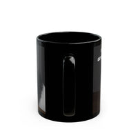 Black ceramic mug featuring a cartoon-style image of a cat sitting at a computer with the funny quote “I work hard so my cat can have a better life.”