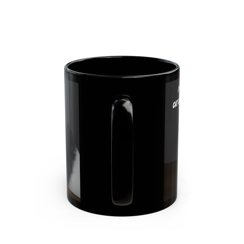 Black ceramic mug featuring a cartoon-style image of a cat sitting at a computer with the funny quote “I work hard so my cat can have a better life.”