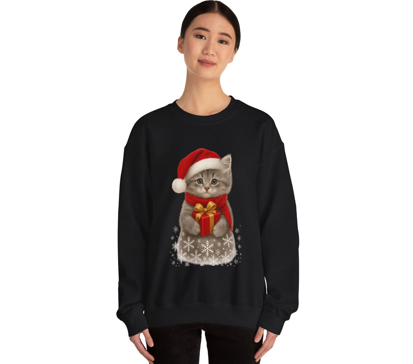 Black sweatshirt featuring a gray kitten wearing a Santa hat and red scarf, holding a small red gift box with a gold bow, surrounded by snowflake designs.