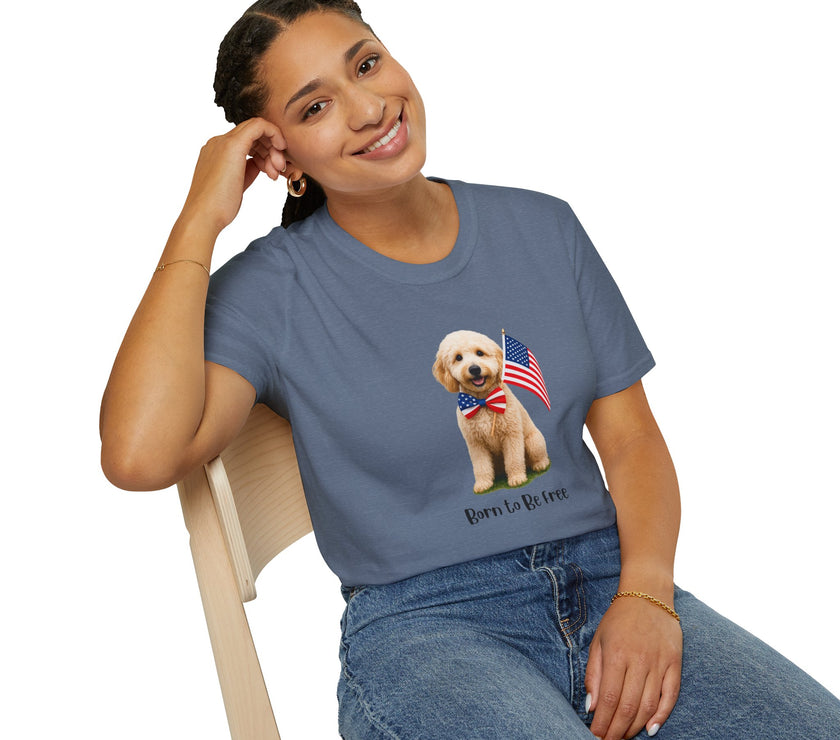 Female wearing T-shirt featuring a cute golden doodle puppy wearing an American flag bow tie and holding a small U.S. flag, with the phrase 'Born to Be Free' printed below the image.