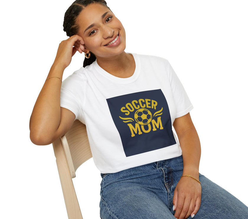 Woman wearing a white t-shirt with 'Soccer Mum' design, sitting on a chair.
