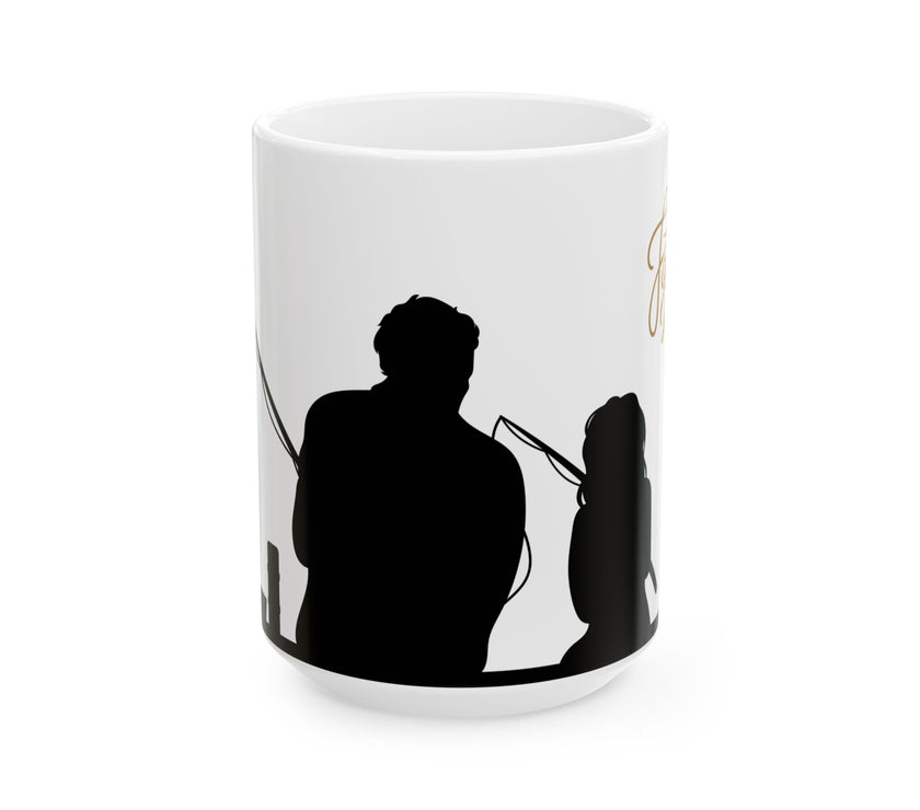 White ceramic mug featuring a silhouette of a child holding a fishing rod next to an adult figure, with the words "Happy Father's Day" in gold script above—an ideal gift for dads who love fishing and family time.