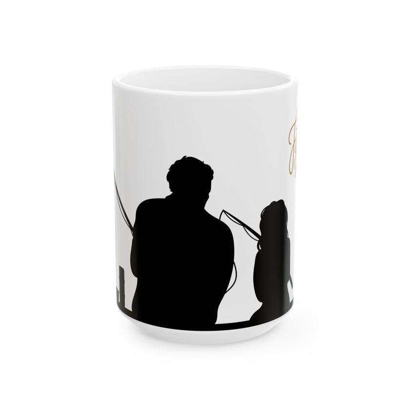 White ceramic mug featuring a silhouette of a child holding a fishing rod next to an adult figure, with the words "Happy Father's Day" in gold script above—an ideal gift for dads who love fishing and family time.