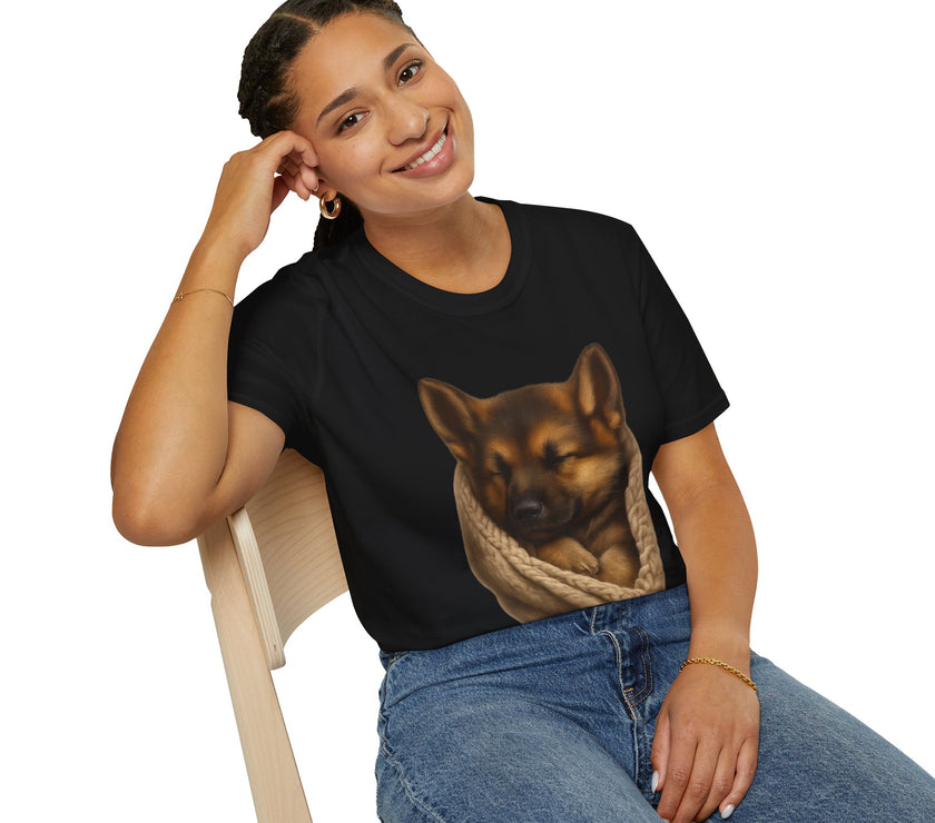 Person wearing a black t-shirt with a dog graphic, sitting on a chair against a white background