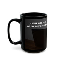 Black ceramic mug featuring a cartoon-style image of a cat sitting at a computer with the funny quote “I work hard so my cat can have a better life.”