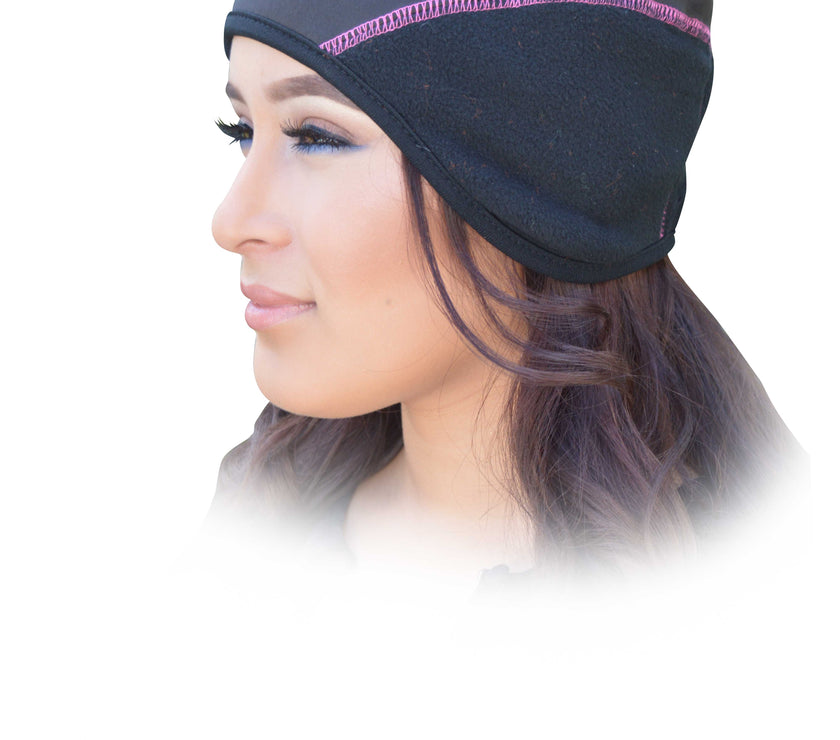 Woman wearing a black head cover with pink trim on a white background