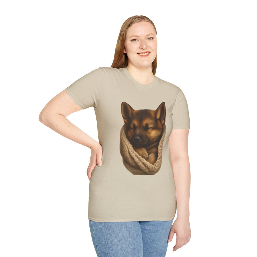 Person wearing a beige t-shirt with a graphic of a dog in a sling on a white background