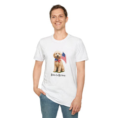 Male wearing T-shirt featuring a cute golden doodle puppy wearing an American flag bow tie and holding a small U.S. flag, with the phrase 'Born to Be Free' printed below the image.