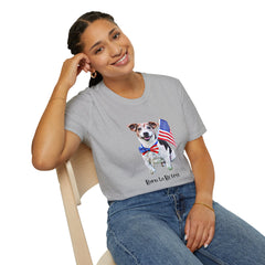 Female wearing T-shirt featuring a cute  puppy wearing an American flag bow tie and holding a small U.S. flag, with the phrase 'Born to Be Free' printed below the image.