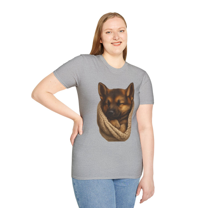 Person wearing a gray t-shirt with a graphic of a dog in a rope bag on a white background