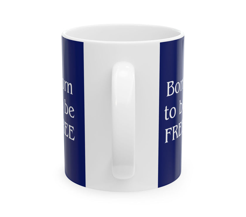 A ceramic mug featuring a Rottweiler sitting on grass, wearing a red, white, and blue bow tie, and holding an American flag against a dark blue background. with the message "Born to be Free"