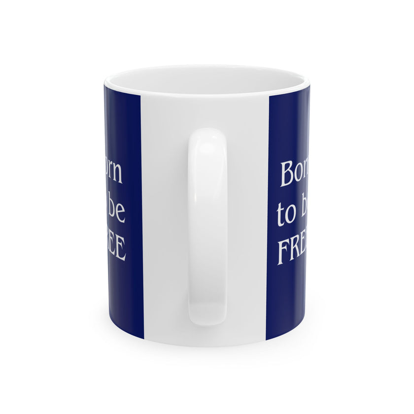 A ceramic mug featuring a Rottweiler sitting on grass, wearing a red, white, and blue bow tie, and holding an American flag against a dark blue background. with the message "Born to be Free"